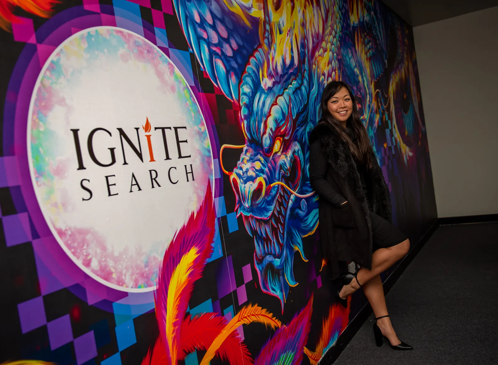 Anqi beside her Ignite Search mural