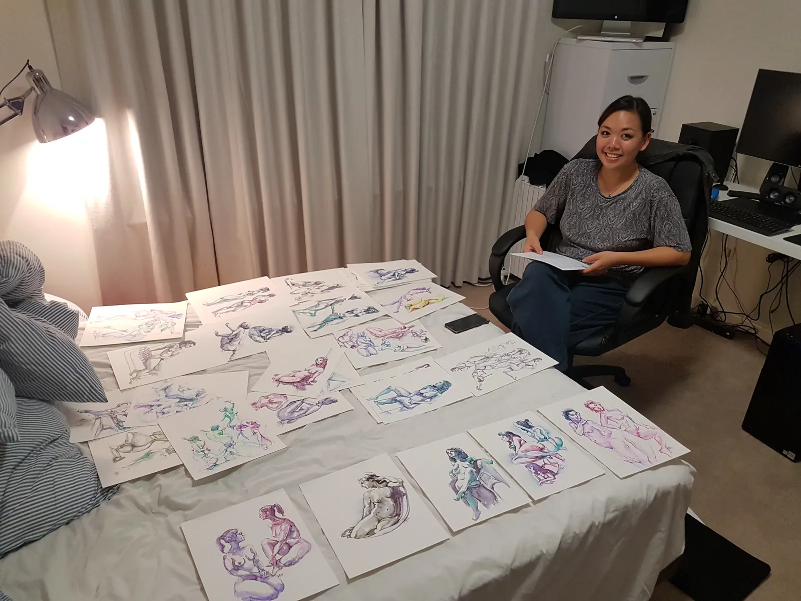 Anqi with a bed covered in her drawings