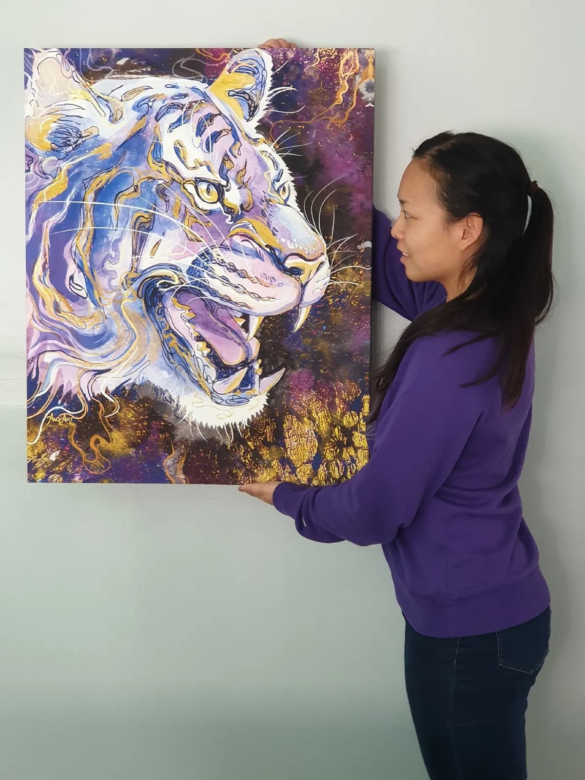 Anqi holding a tiger painting