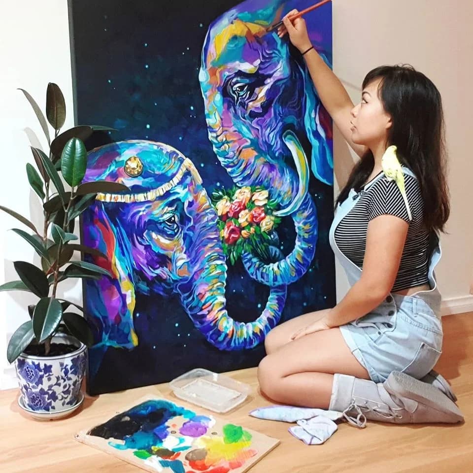 Anqi painting her elephants canvas at home