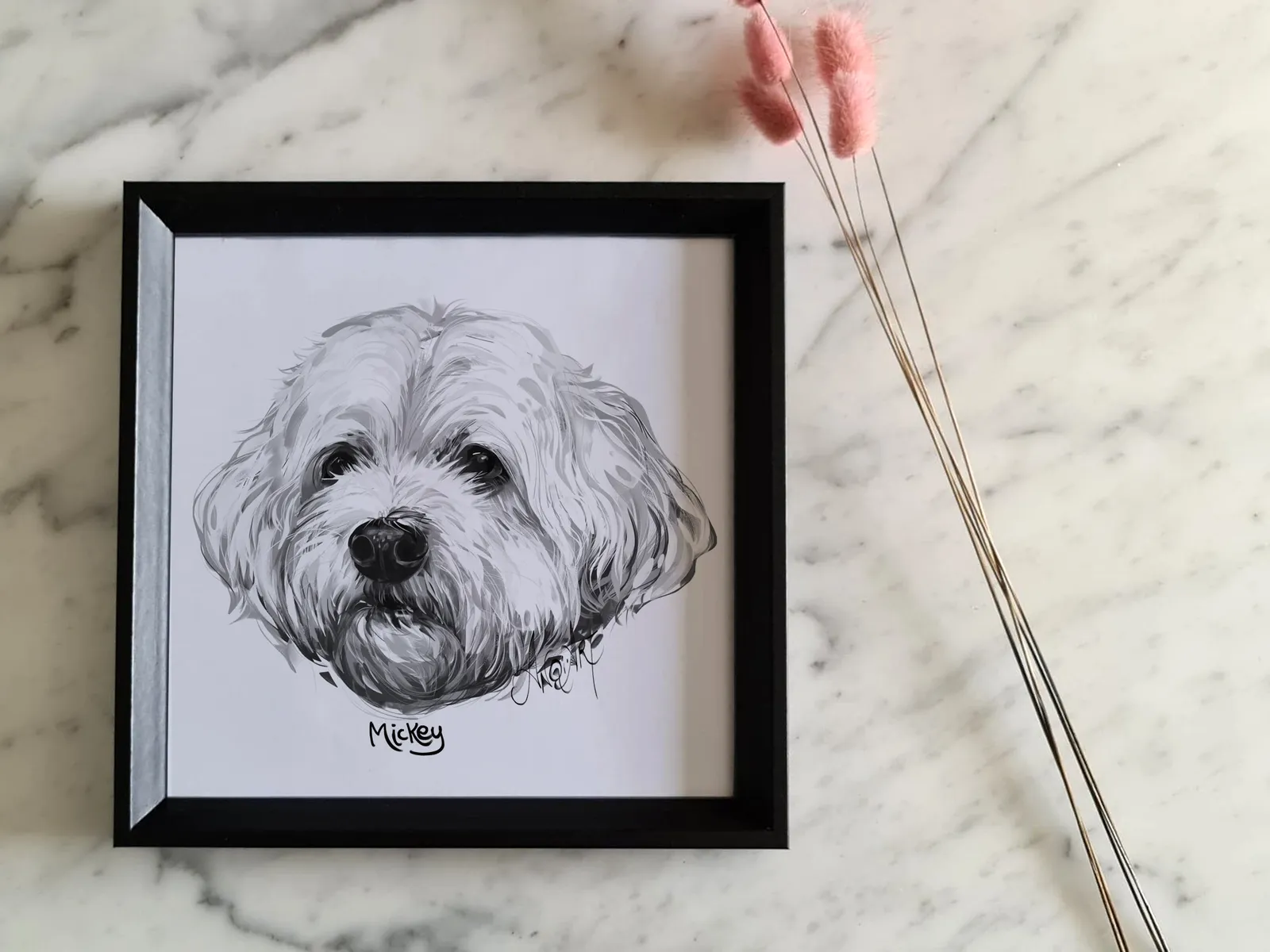 Framed pet portrait on a marble table